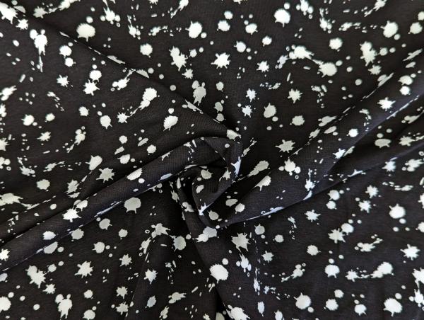 Baumwolljersey Weiße Farbkleckse auf Schwarz 35 x 150 cm